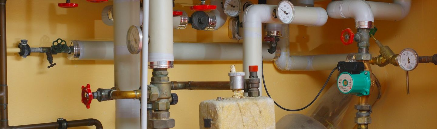 Boiler room with pipework, valves and pressure gauges of a heating installation